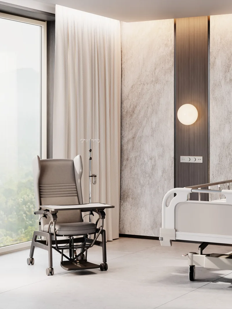 Care Pflegesessel, mobile Variante, im Patientenzimmer neben dem Klinikbett